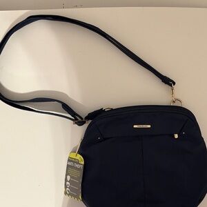 Travel safely with navy blue Travelon Crossbody Bag, with tags, secure zippers